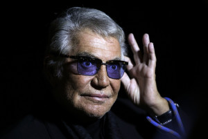 File photo of designer Roberto Cavalli acknowledging the audience at the end of his Spring/Summer 2014 collection during Milan Fashion Week